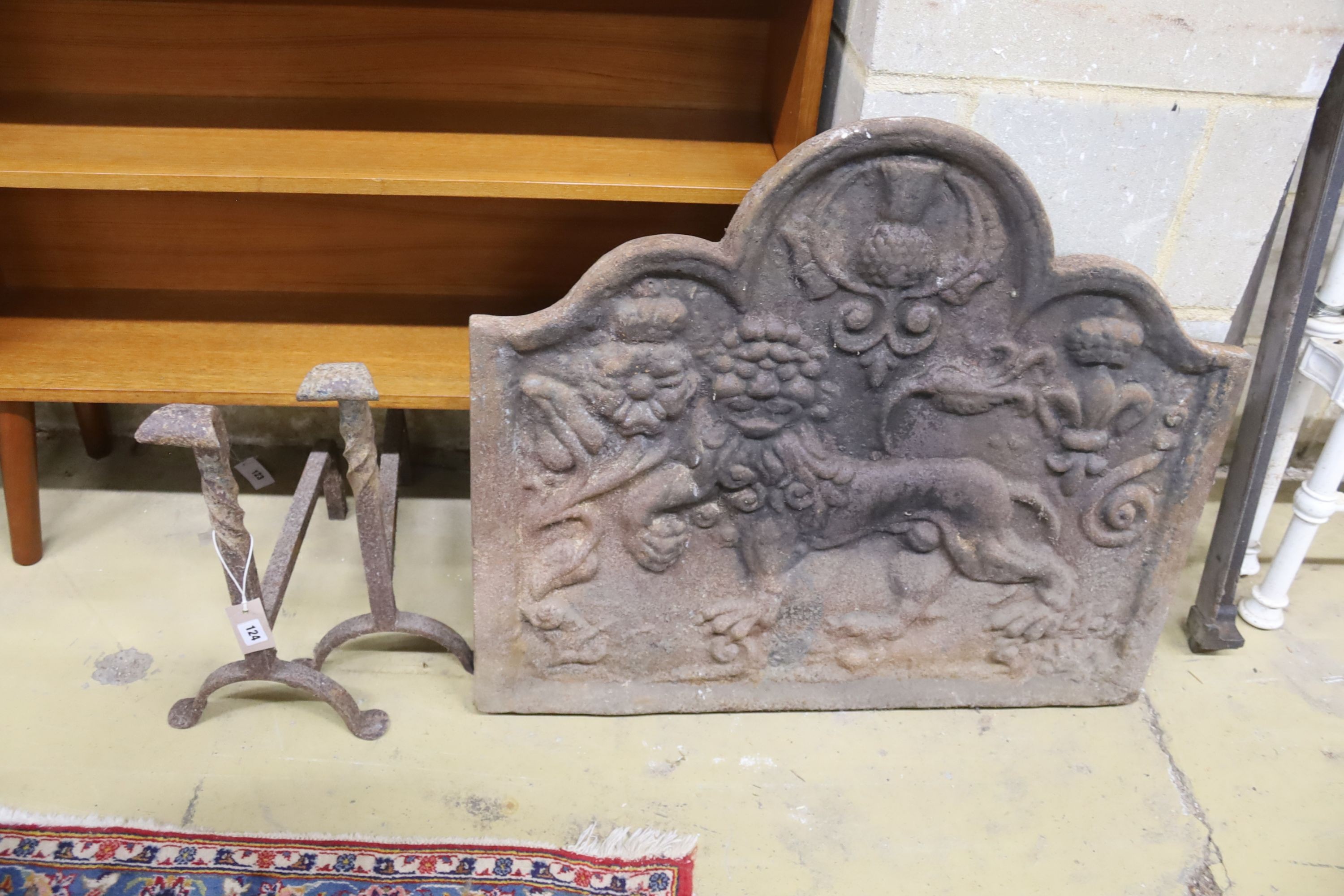 A heavy cast iron fire back, length 79cm, height 67cm together with a pair of fire dogs (3)